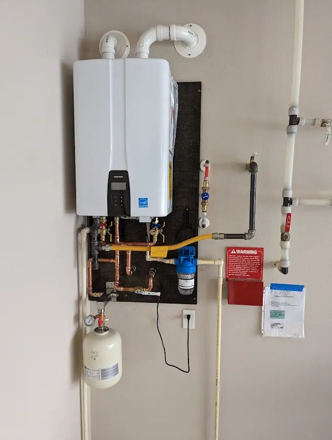 Professional plumber installing copper piping in a Yuba City home